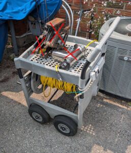 Plastic garden cart with extension cord & power bar.