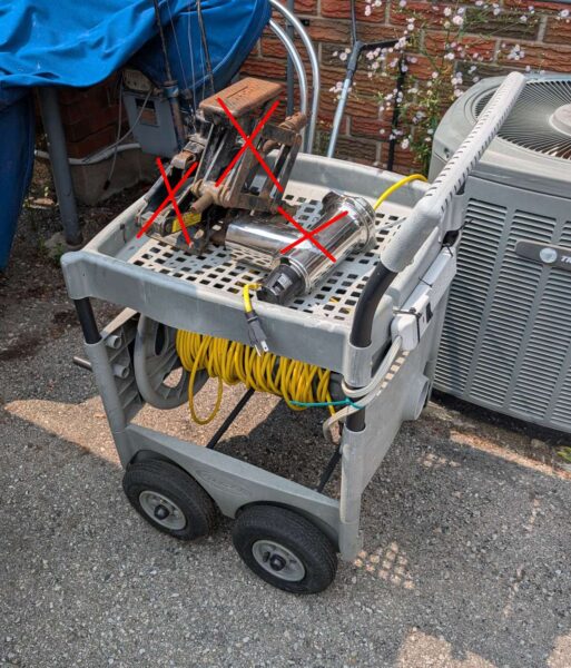 Plastic garden cart with extension cord & power bar.