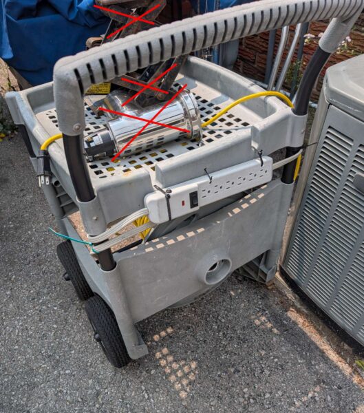 Plastic garden cart with extension cord & power bar.