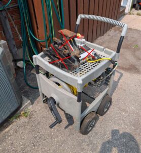 Plastic garden cart with extension cord & power bar.