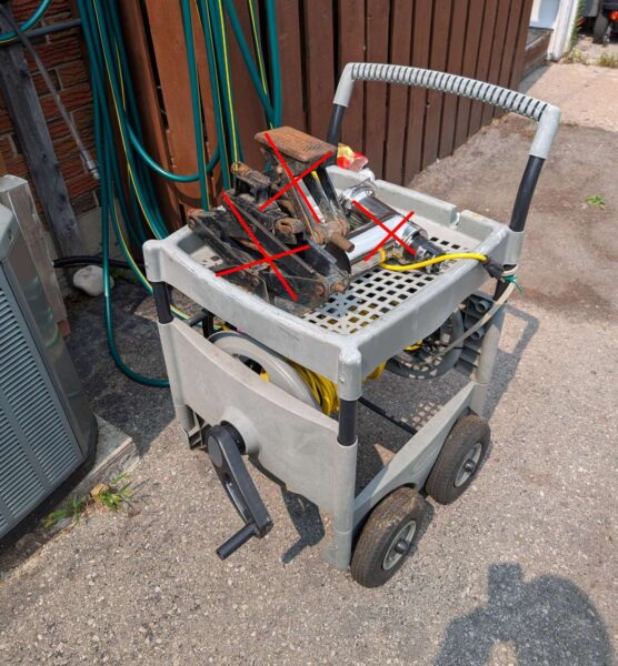 Plastic garden cart with extension cord & power bar.